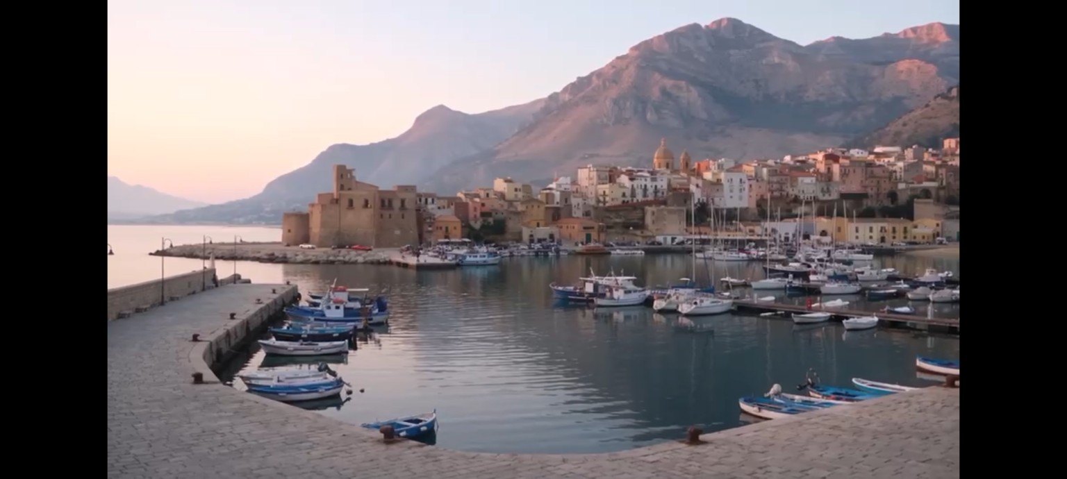 A Sicilian coastal harbor with fishing boats