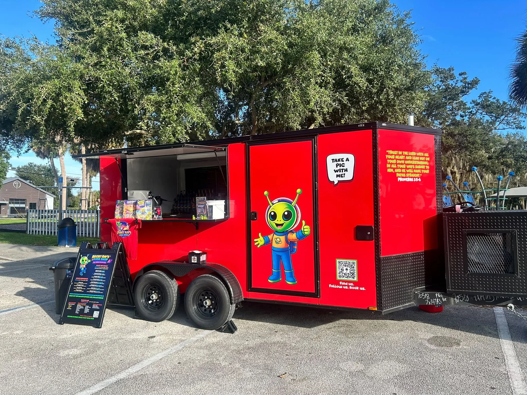 Rocket Ray’s real red soda trailer with their green alien mascot